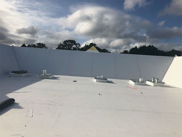 A white roof with a blue sky in the background.